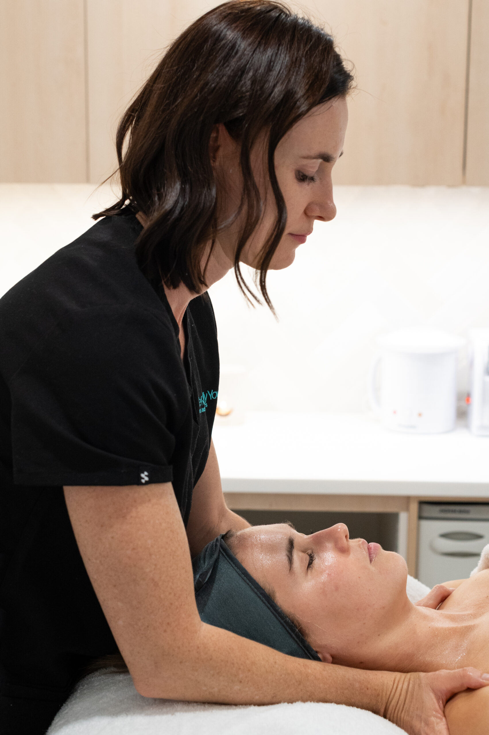 a woman massaging a woman's head