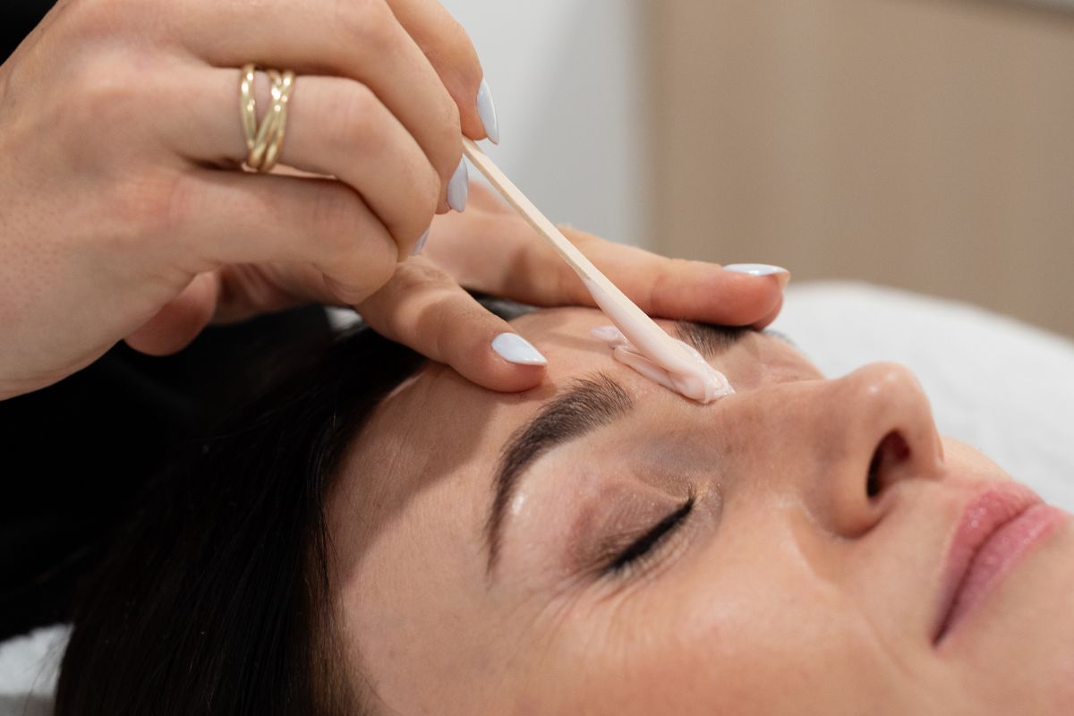Closeup of wax removal treatment on woman's face